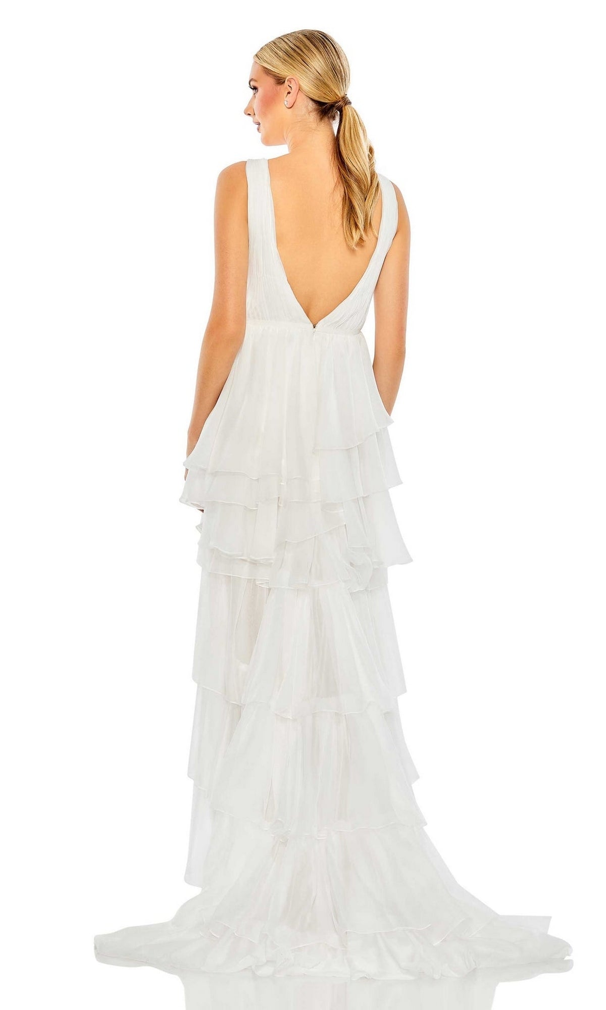 A woman stands facing away, wearing the Deep V-Neck High-Low Ruffled Party Dress 55320 in white, featuring a sleeveless design, deep V-back, and tiered ruffled layers against a plain white background.